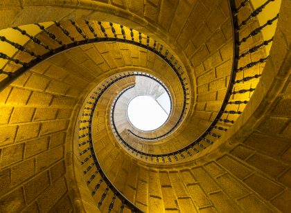 low angle view of stone spiral staircase towards sky
